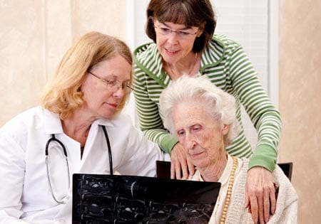 Caregiver and family assist a senior